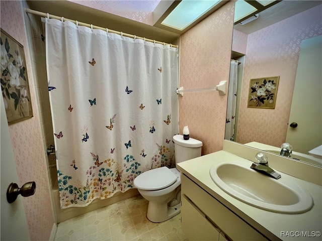 full bathroom featuring shower / bath combo, vanity, and toilet