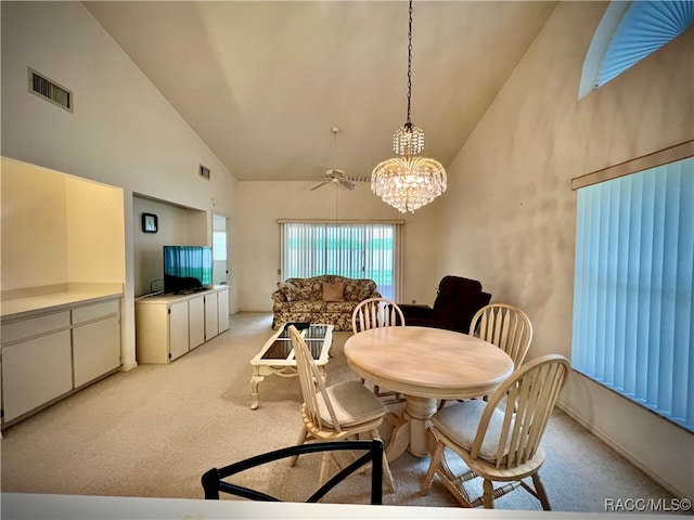 dining area with ceiling fan, high vaulted ceiling, and light colored carpet