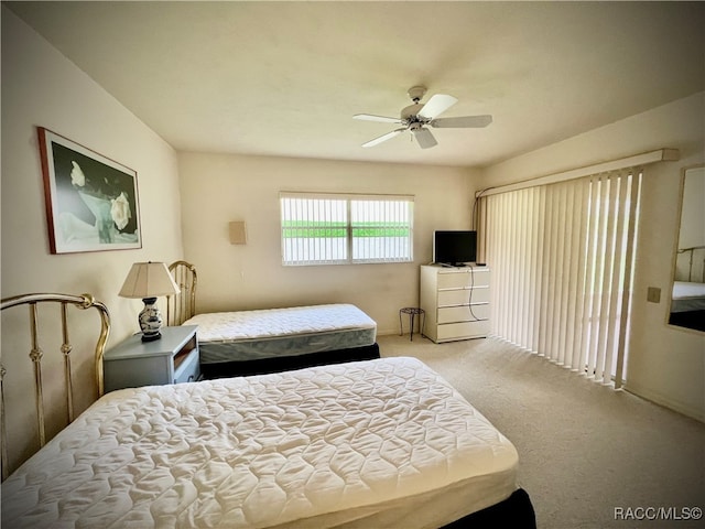 bedroom featuring ceiling fan and light carpet