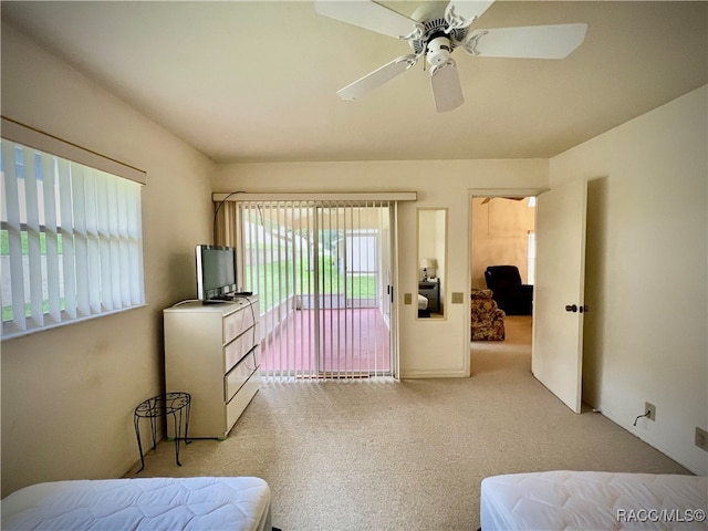 bedroom with access to exterior, light carpet, and ceiling fan