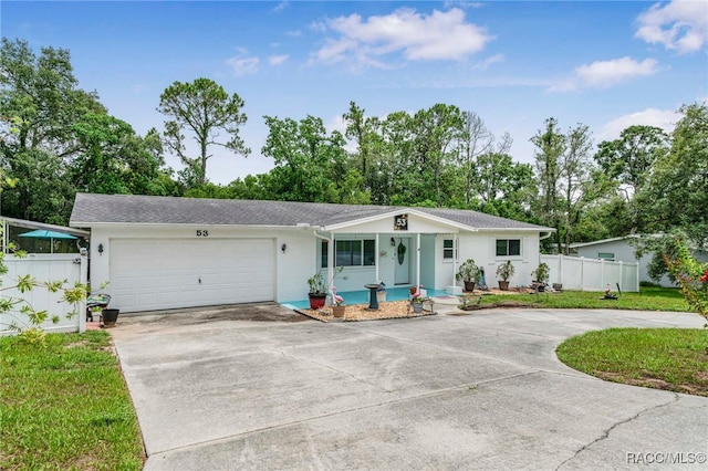 53 S Columbus St, Beverly Hills, FL 34465 - ranch-style house with concrete driveway, a garage, and covered porch