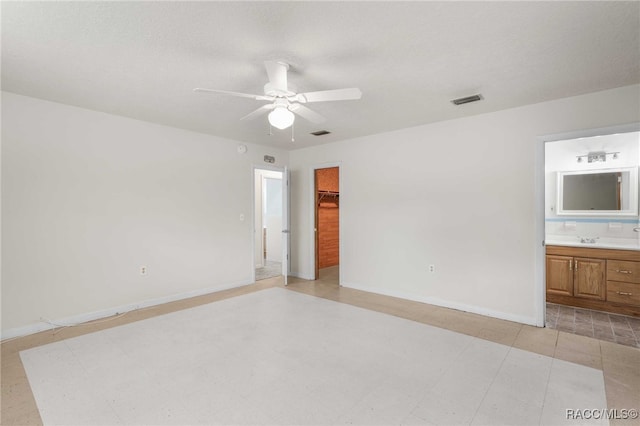 53 S Columbus St, Beverly Hills, FL 34465 - unfurnished bedroom with ensuite bath, a closet, ceiling fan, and a walk in closet