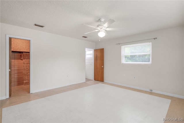53 S Columbus St, Beverly Hills, FL 34465 - unfurnished bedroom featuring a spacious closet, a textured ceiling, ceiling fan, tile patterned floors, and a closet