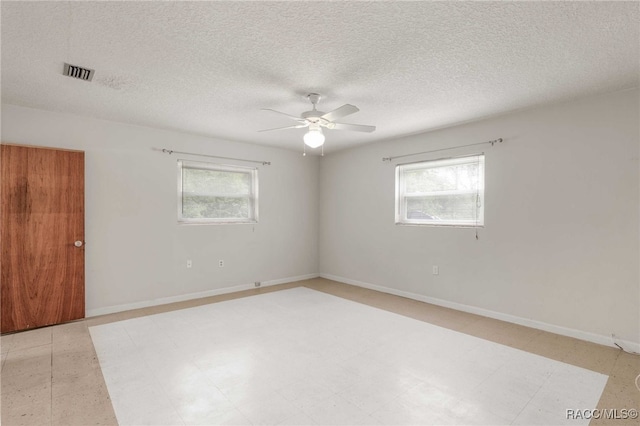 53 S Columbus St, Beverly Hills, FL 34465 - empty room featuring healthy amount of natural light, ceiling fan, and a textured ceiling