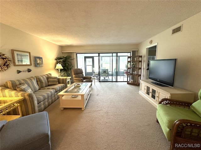 carpeted living room with a textured ceiling