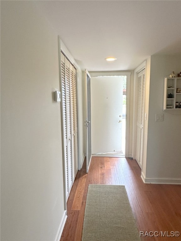 corridor with wood-type flooring