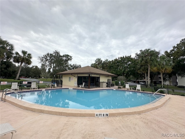 view of swimming pool with a patio