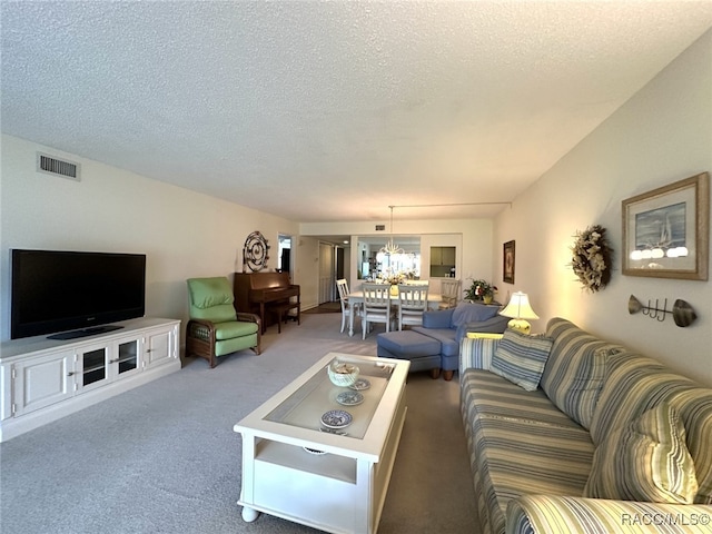 living room with carpet flooring and a textured ceiling