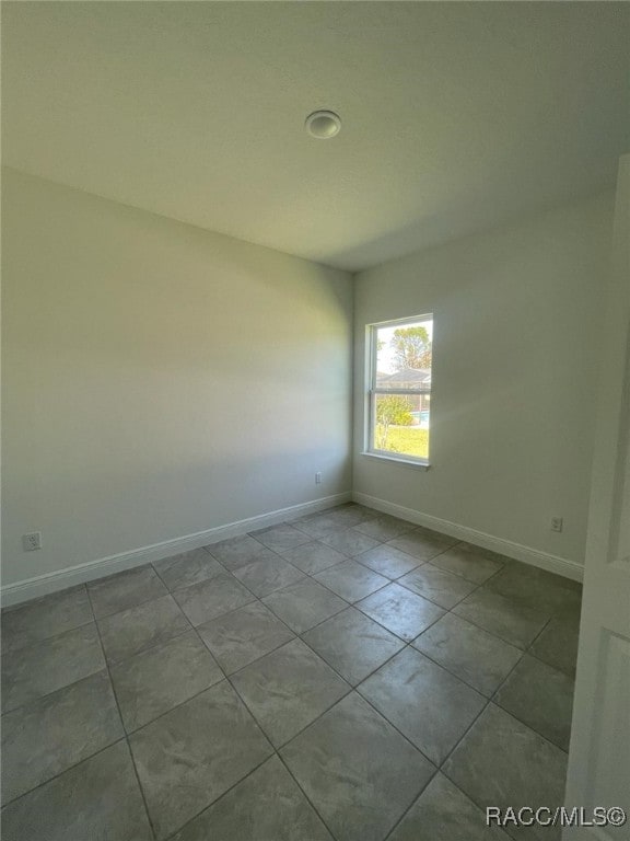 spare room with light tile patterned floors