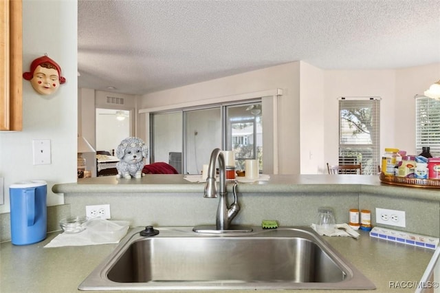 kitchen with a textured ceiling and sink