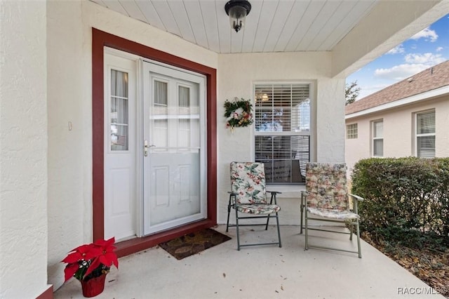 view of exterior entry with covered porch