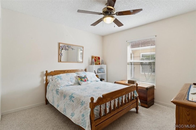 bedroom with light carpet, a textured ceiling, and ceiling fan