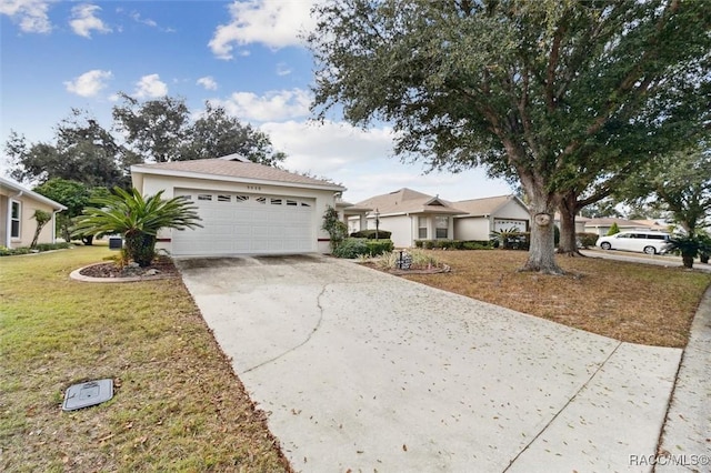 single story home with a garage and a front lawn