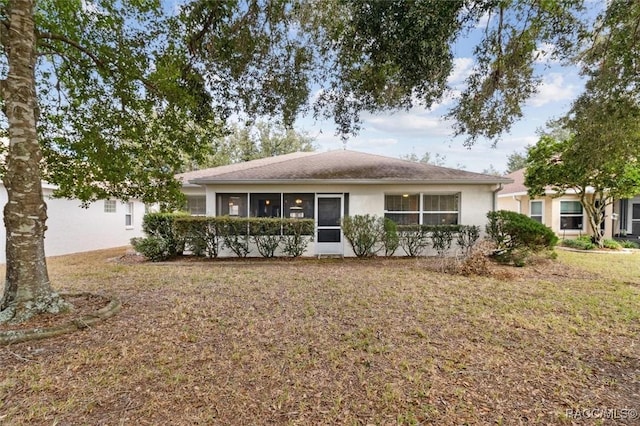 ranch-style house with a sunroom and a front yard