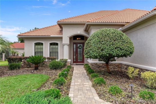 1576 N Eagle Ridge Path, Hernando, FL 34442 - view of exterior entry with stucco siding and a tiled roof