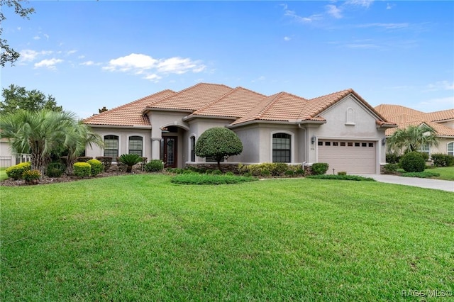 1576 N Eagle Ridge Path, Hernando, FL 34442 - mediterranean / spanish home featuring stucco siding, an attached garage, concrete driveway, a front yard, and a tile roof