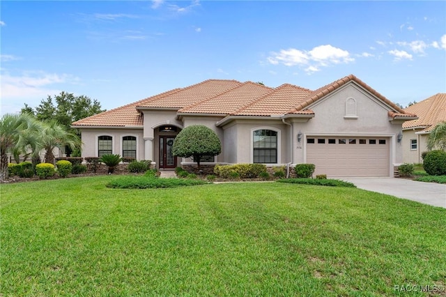 1576 N Eagle Ridge Path, Hernando, FL 34442 - mediterranean / spanish house with stucco siding, a garage, driveway, a front yard, and a tile roof