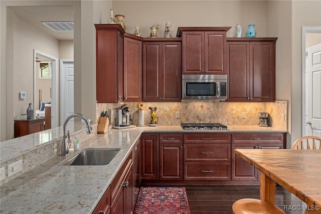 1576 N Eagle Ridge Path, Hernando, FL 34442 - kitchen featuring appliances with stainless steel finishes, tasteful backsplash, light stone countertops, and dark wood-type flooring