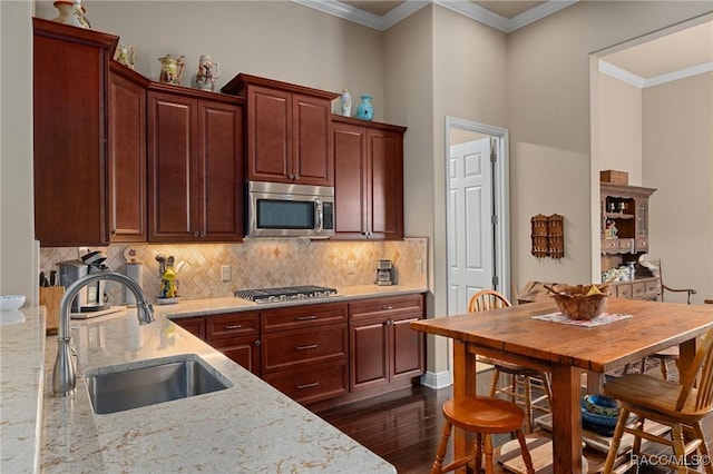 1576 N Eagle Ridge Path, Hernando, FL 34442 - kitchen with stainless steel appliances, dark wood-style floors, tasteful backsplash, light stone countertops, and ornamental molding