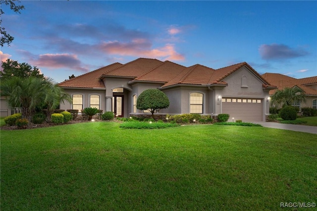 1576 N Eagle Ridge Path, Hernando, FL 34442 - mediterranean / spanish home with stucco siding, a front lawn, concrete driveway, a garage, and a tile roof