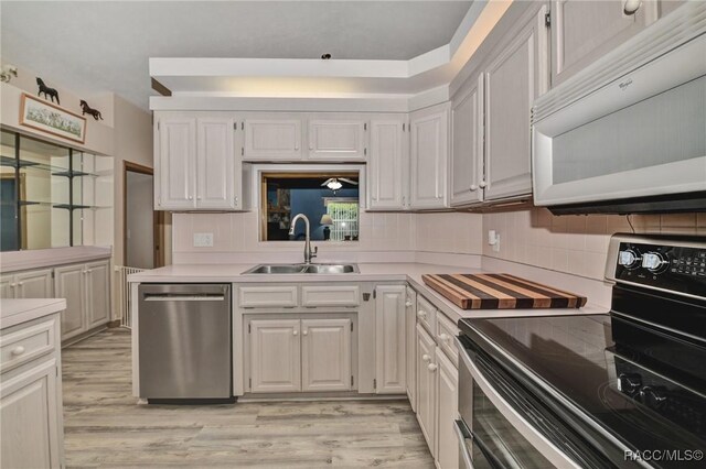 3670 W Cogwood Cir, Beverly Hills, FL 34465 - kitchen featuring stainless steel appliances, a sink, light countertops, and tasteful backsplash