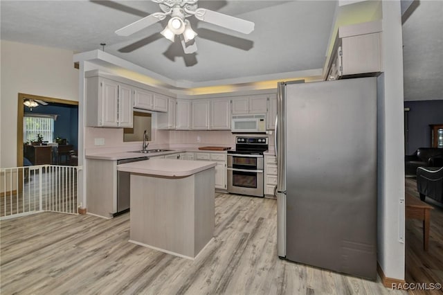 3670 W Cogwood Cir, Beverly Hills, FL 34465 - kitchen with appliances with stainless steel finishes, a ceiling fan, light countertops, a sink, and light wood-type flooring