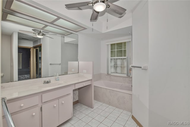 bathroom with tiled bath, ceiling fan, tile patterned flooring, and vanity