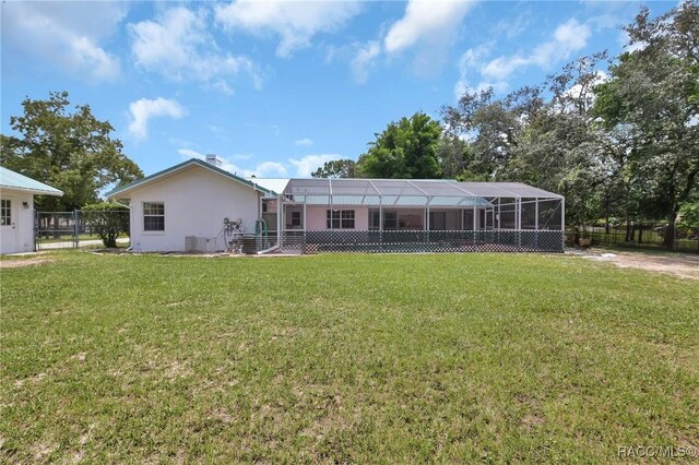 3670 W Cogwood Cir, Beverly Hills, FL 34465 - rear view of house featuring stucco siding and glass enclosure