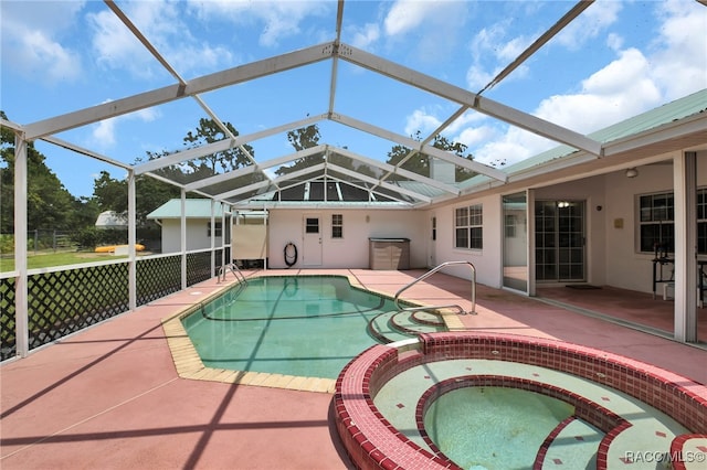 view of swimming pool featuring an in ground hot tub, a patio, and glass enclosure