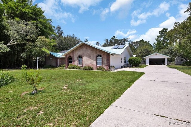 3670 W Cogwood Cir, Beverly Hills, FL 34465 - ranch-style house featuring brick siding, roof mounted solar panels, a front lawn, and an outbuilding