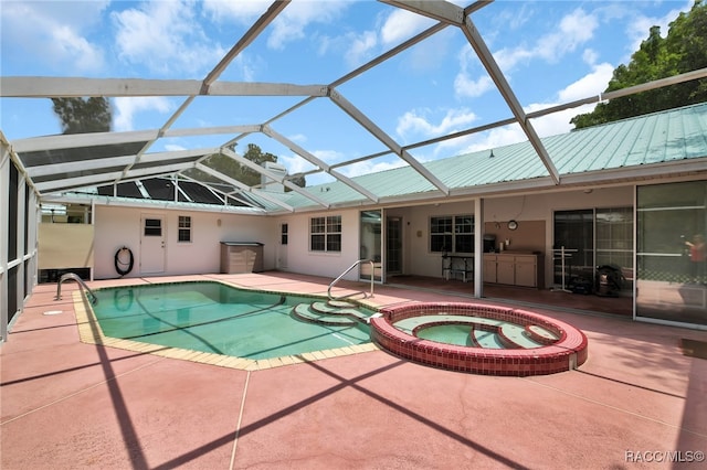 view of pool featuring a lanai, a patio area, and an in ground hot tub