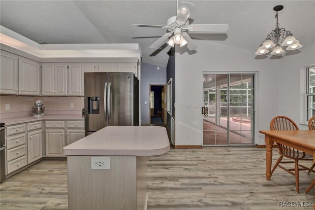 3670 W Cogwood Cir, Beverly Hills, FL 34465 - kitchen featuring stainless steel fridge, vaulted ceiling, light wood finished floors, light countertops, and a chandelier
