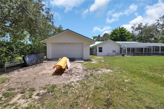 3670 W Cogwood Cir, Beverly Hills, FL 34465 - exterior space featuring a detached garage, a front yard, and stucco siding