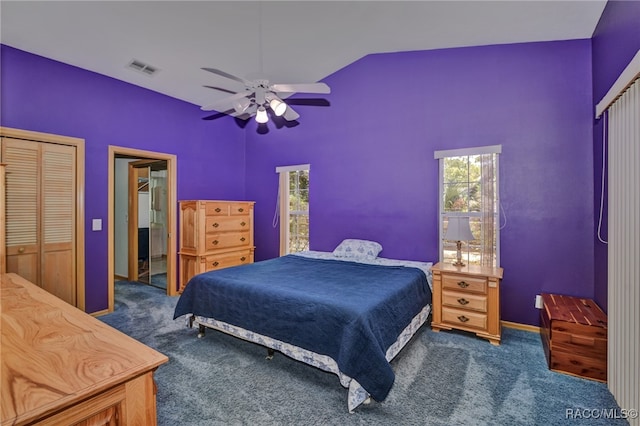 bedroom featuring ceiling fan, a closet, vaulted ceiling, and dark colored carpet