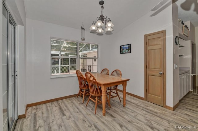 3670 W Cogwood Cir, Beverly Hills, FL 34465 - dining space with light wood-style flooring, baseboards, a chandelier, and lofted ceiling