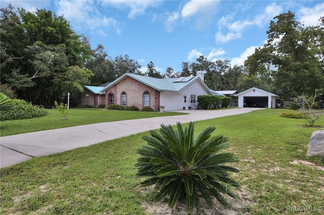 single story home with a front lawn, a garage, and solar panels