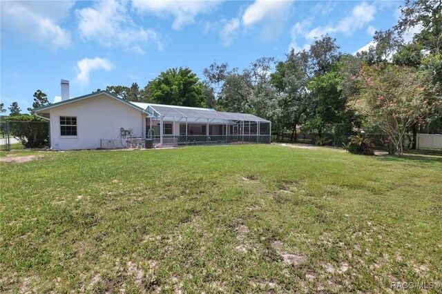 3670 W Cogwood Cir, Beverly Hills, FL 34465 - back of house with stucco siding, glass enclosure, and a chimney