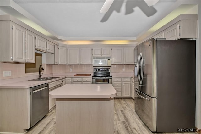 3670 W Cogwood Cir, Beverly Hills, FL 34465 - kitchen featuring appliances with stainless steel finishes, a sink, a ceiling fan, light countertops, and light wood-type flooring