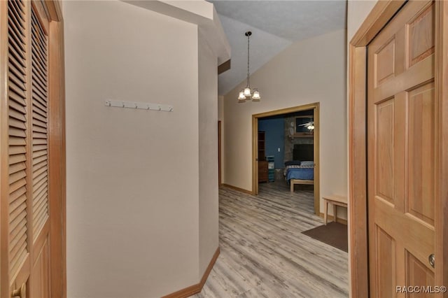 3670 W Cogwood Cir, Beverly Hills, FL 34465 - hall with lofted ceiling, light wood-style flooring, a chandelier, and baseboards