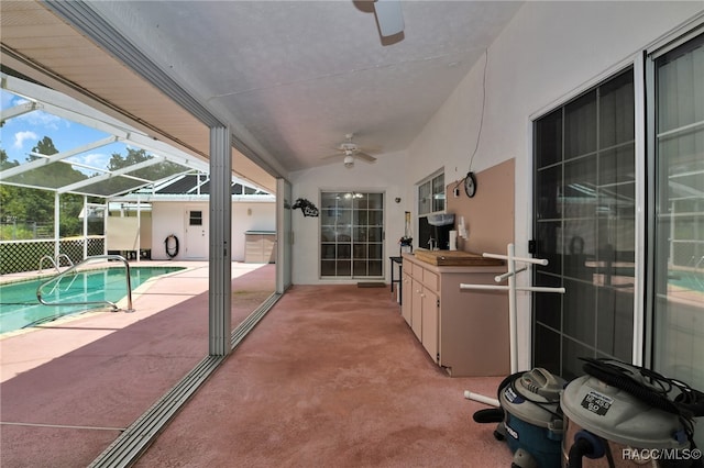 view of patio with glass enclosure and ceiling fan