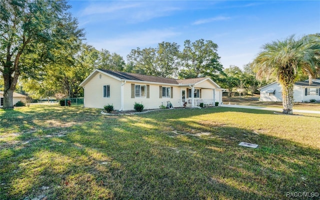 single story home with a porch and a front yard