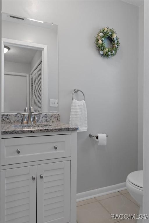 70 W Casurina Pl, Beverly Hills, FL 34465 - bathroom featuring toilet, vanity, and baseboards