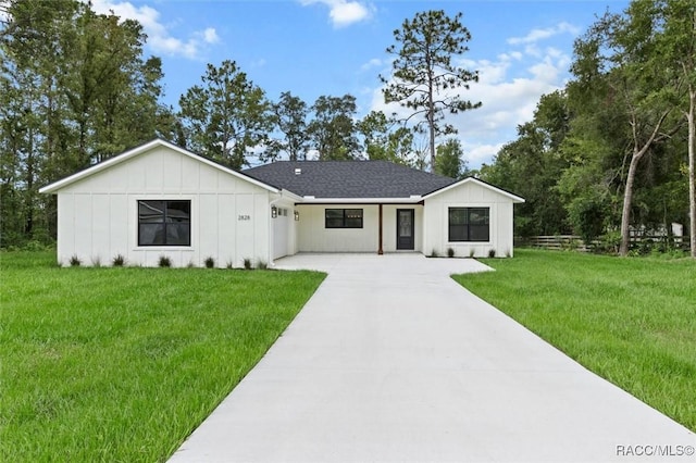 2828 E Celina St, Inverness, FL 34453 - modern inspired farmhouse featuring board and batten siding, concrete driveway, and a front yard
