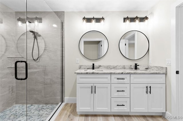 2828 E Celina St, Inverness, FL 34453 - full bathroom featuring double vanity, a stall shower, and wood finished floors