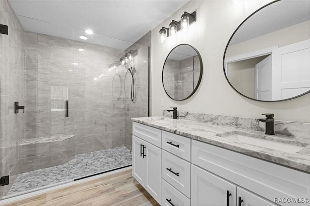2828 E Celina St, Inverness, FL 34453 - bathroom with double vanity, a shower stall, wood finished floors, and recessed lighting