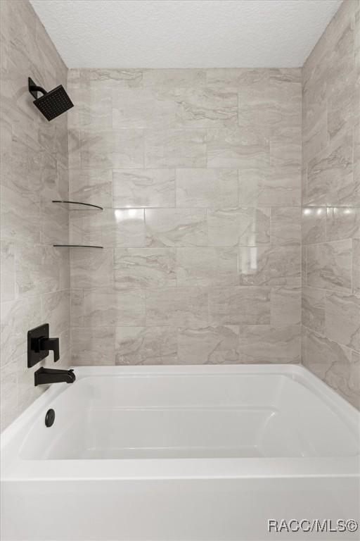 2828 E Celina St, Inverness, FL 34453 - bathroom featuring bathing tub / shower combination and a textured ceiling
