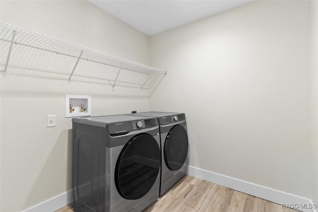 2828 E Celina St, Inverness, FL 34453 - laundry room with light wood-type flooring and washing machine and dryer