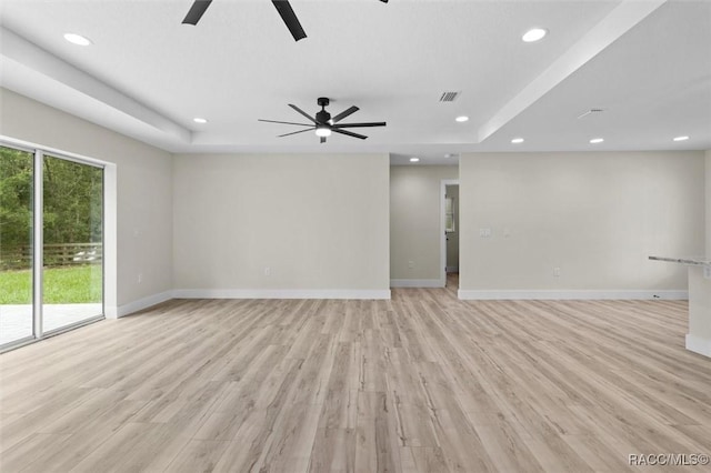 2828 E Celina St, Inverness, FL 34453 - empty room featuring a ceiling fan, recessed lighting, light wood-style flooring, and a raised ceiling
