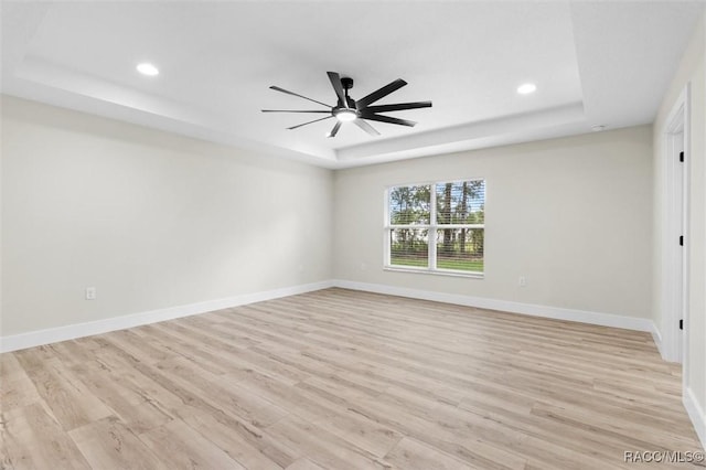 2828 E Celina St, Inverness, FL 34453 - empty room with a raised ceiling, light wood-type flooring, recessed lighting, and a ceiling fan