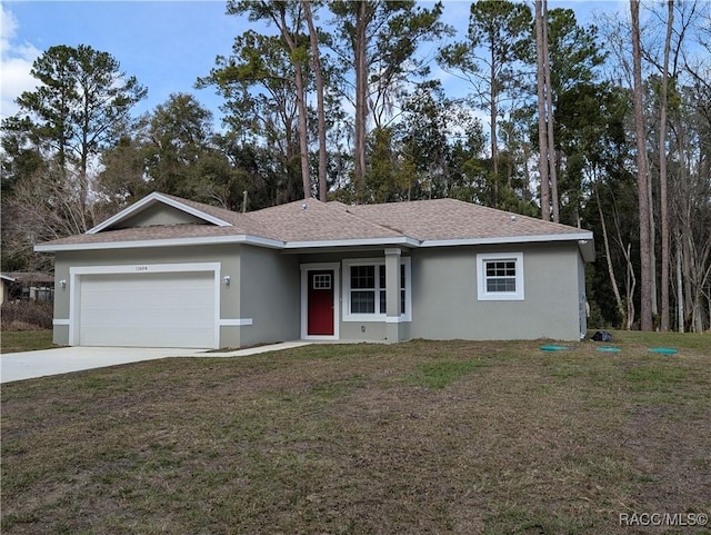 ranch-style house featuring a garage and a front lawn